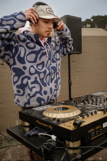 James Blonde cueing music at the decks